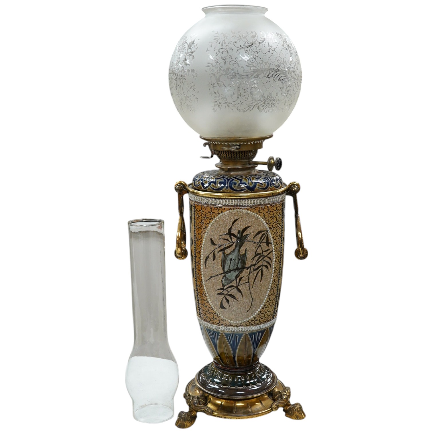 Florence Barlow for Doulton Lambeth, a stoneware oil lamp, pate-sur-pate decoration, dated 1883, the reservoir by another assistant, 47cm to top of burner. Condition - fair to good (some wear)